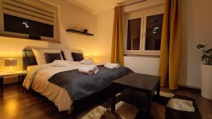 a bedroom with a large bed with two towels on it at Apartament na Poli in Wałbrzych