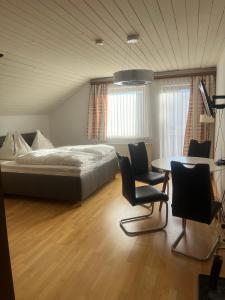 1 dormitorio con 1 cama, mesa y sillas en Frühstückspension Eichberger en Pöls