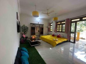 a bedroom with a yellow bed in a room at Cool viva Goa villa near beach in Colva
