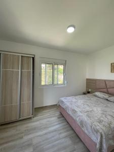 a bedroom with a large bed and a window at Summer Dreams in Bar