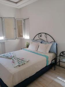 a bedroom with a bed with towels on it at Dar Sahhouma in Hammamet Nord