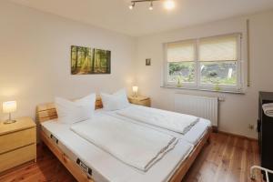 Ένα ή περισσότερα κρεβάτια σε δωμάτιο στο Ferienhaus Reinerzau "Kleine Kinzig"