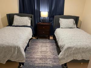 um quarto com duas camas e uma mesa com um candeeiro em Newly Remodeled Family Friendly 3B/2B House em Henderson