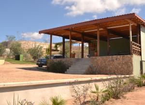 a building with a car parked in front of it at Casa Berty 4 in Ensenada
