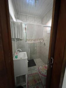 a bathroom with a shower and a sink and a toilet at Casa aconchegante ótima para rlx in Barra Velha