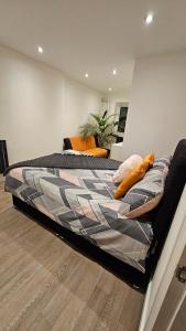 a large bed in a room with at Cosy Corner Suite in Bradford