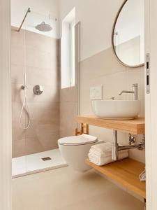 a bathroom with a toilet and a sink and a shower at Camere Assúd in Leuca