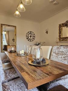 a dining room with a wooden table with candles on it at Antfield house in Inverness
