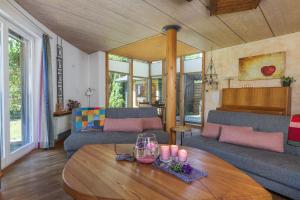 a living room with couches and a table with candles at Ferienhaus Dornstetten in Dornstetten