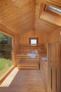 a sauna in a wooden cabin with a window at Ferienhaus Dornstetten in Dornstetten