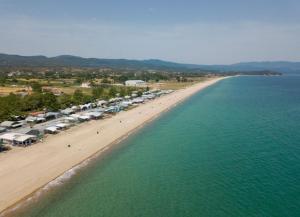 an aerial view of a beach with a group of tents at ΚΟΧΥΛΙ in Ierissos