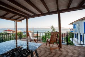 Boyalıca的住宿－Lake360，露台设有玻璃桌子和椅子,甲板上设有