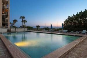 a large swimming pool in the middle of a building at Beachfront Condo with Pool and Hot Tub Reflections On The Gulf 504 in Clearwater Beach
