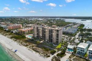 an aerial view of a beach with buildings and the ocean at Beachfront Condo with Pool and Hot Tub Reflections On The Gulf 504 in Clearwater Beach