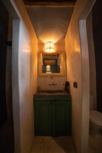 a bathroom with a green sink and a mirror at Hotel & Riad Veridis in Marrakesh