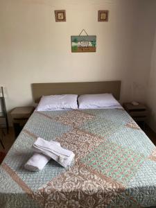 1 dormitorio con 1 cama con 2 toallas en Habitación Juspe, en Colonia del Sacramento