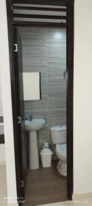 a bathroom with a toilet and a sink at Habitaciones Cataleya Valledupar in Valledupar