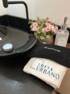 a towel with the words hurtloronto sitting on a counter at Lofts Urbano in Urubici