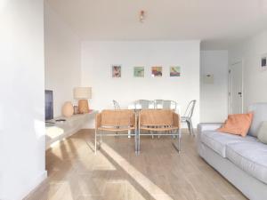 a living room with a couch and a table and chairs at Bay House Baleal - surf beach across the road in Ferrel