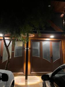 uma casa com uma garagem de madeira com um carro estacionado em frente em Lofts Urbano em Urubici