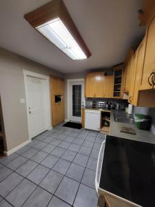 a large kitchen with a skylight in the ceiling at A Place to Call Home in Edmonton