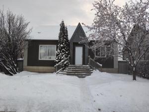 a house with a christmas tree in the snow at A Place to Call Home in Edmonton