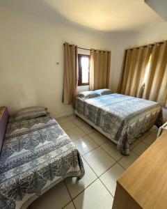 sypialnia z 2 łóżkami i oknem w obiekcie Casa em Bananeiras PB w mieście Bananeiras
