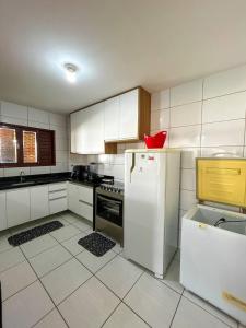 a kitchen with a refrigerator and a red bowl on top of it at Casa em Bananeiras PB in Bananeiras