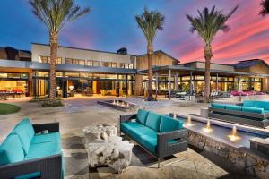 a building with palm trees in front of it at Upscale Fully Furnished Resort Home-Gated Golf Community in Rio Verde