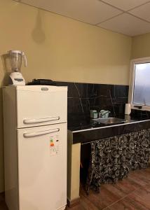 a kitchen with a blender on top of a refrigerator at Casaquinta in Villa María