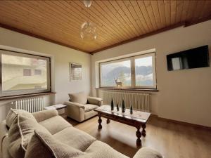 a living room with a couch and a table at Mountain Chalet Tre Marie in Cavalese