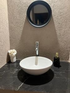 a white sink on a counter with a mirror at Casaquinta in Villa María