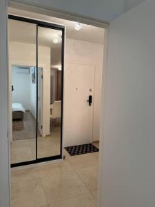 a room with a glass door and a bedroom at Apartament JANICKIEGO 159 parking free in Poznań +12 photos
