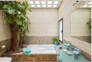 a bathroom with a tub and a sink at Villa Leonor in Es Calo +90 photos