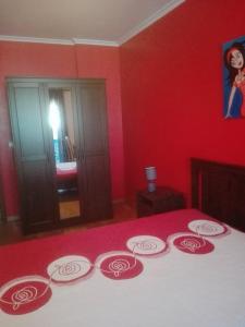 a red bedroom with a bed with red walls at Casa Modesta II in Beja