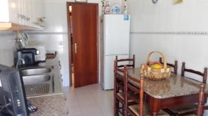 a kitchen with a table with a basket of fruit on it at Casa Modesta II in Beja