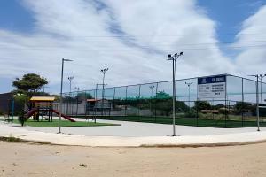 a tennis court with a playground in front of a building at Solares Boa Estada in Búzios