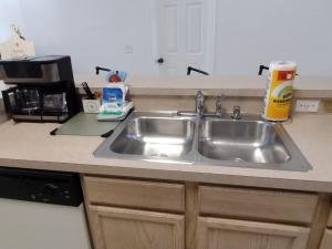 a kitchen counter with a stainless steel sink at Home from Home 5 bedroom villa in Davenport