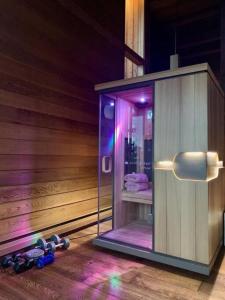 a sauna with a shower with purple lights in it at Mtn House w/ Stunning Views, Sauna, HotTub, Trails in Boulder