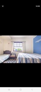 Ένα ή περισσότερα κρεβάτια σε δωμάτιο στο SUITES E QUARTOS CASA PAPAI NOEL