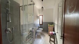 a bathroom with a toilet and a glass shower at Flowers & Angels Home in Santa Maria degli Angeli +10 photos