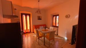 a kitchen with a table and chairs in a room at Flowers & Angels Home in Santa Maria degli Angeli