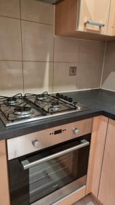 a stove top oven in a kitchen at Two bed Apartment free parking near Colindale Station in Colindale