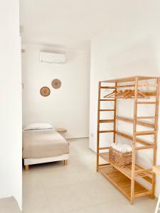 a bedroom with a bunk bed and a ladder at Camere Assúd in Leuca