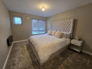 a bedroom with a large bed and a window at New 2 Bedroom Appartment In Manchester - Stretford - Old Trafford Close to Football-Cricket Ground & City Centre in Manchester