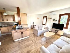a living room with a white couch and a kitchen at Bungalow en Denia in Denia