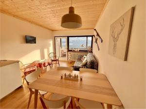 a living room with a wooden table and chairs at Mountain Chalet Tre Marie in Cavalese
