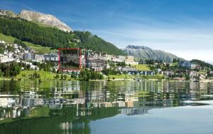 a town on a hill next to a lake at Au Reduit 201 in St. Moritz