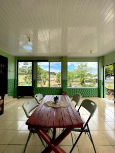 a dining room with a wooden table and chairs at Miravalles Volcano House in Guayabal