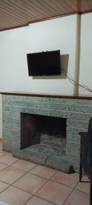 a fireplace with a television on top of it at Hotel Alsacia in Tegucigalpa